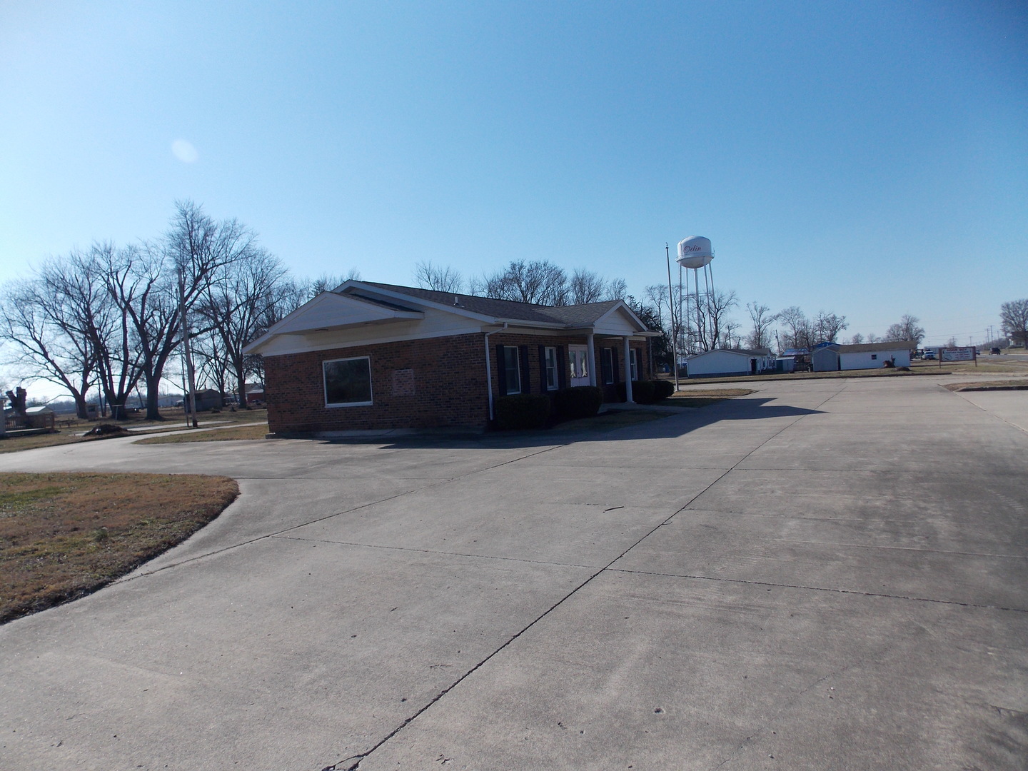 303 West Poplar Street Odin, IL 62870 - Photo 4 of 20 a view of a house with a yard and a car parked in front of it