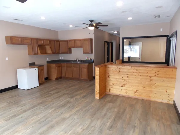 a large kitchen with kitchen island a sink stainless steel appliances and cabinets