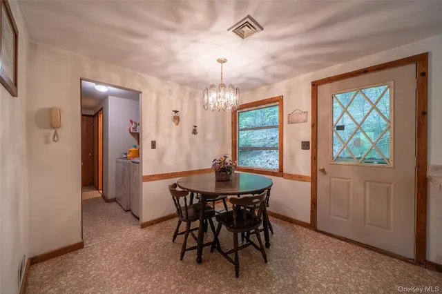 a view of a dining room with furniture window and outside view