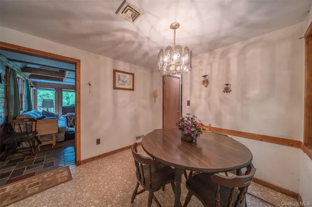 a view of a dining room with furniture and chandelier
