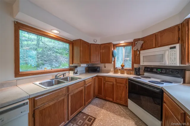 a kitchen with a sink stove and microwave