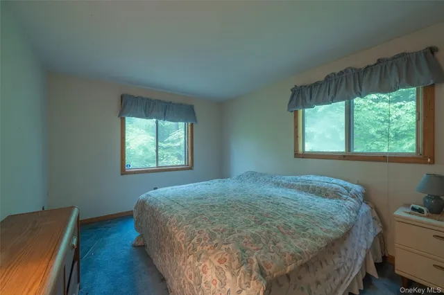 a bed sitting in a bedroom next to a window