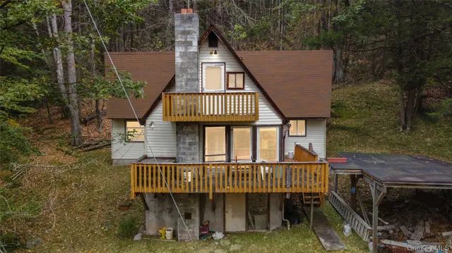 a view of a roof deck with chair and potted plants