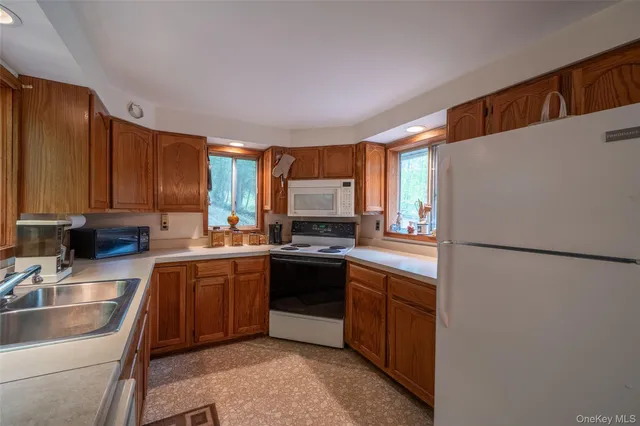 a kitchen with stainless steel appliances granite countertop a refrigerator sink and cabinets