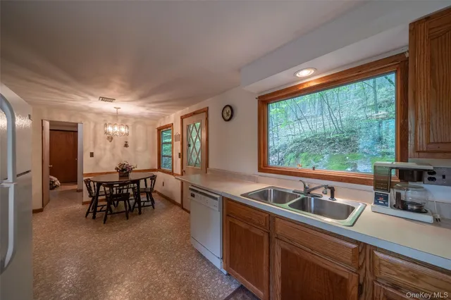 a kitchen with sink a table and chairs