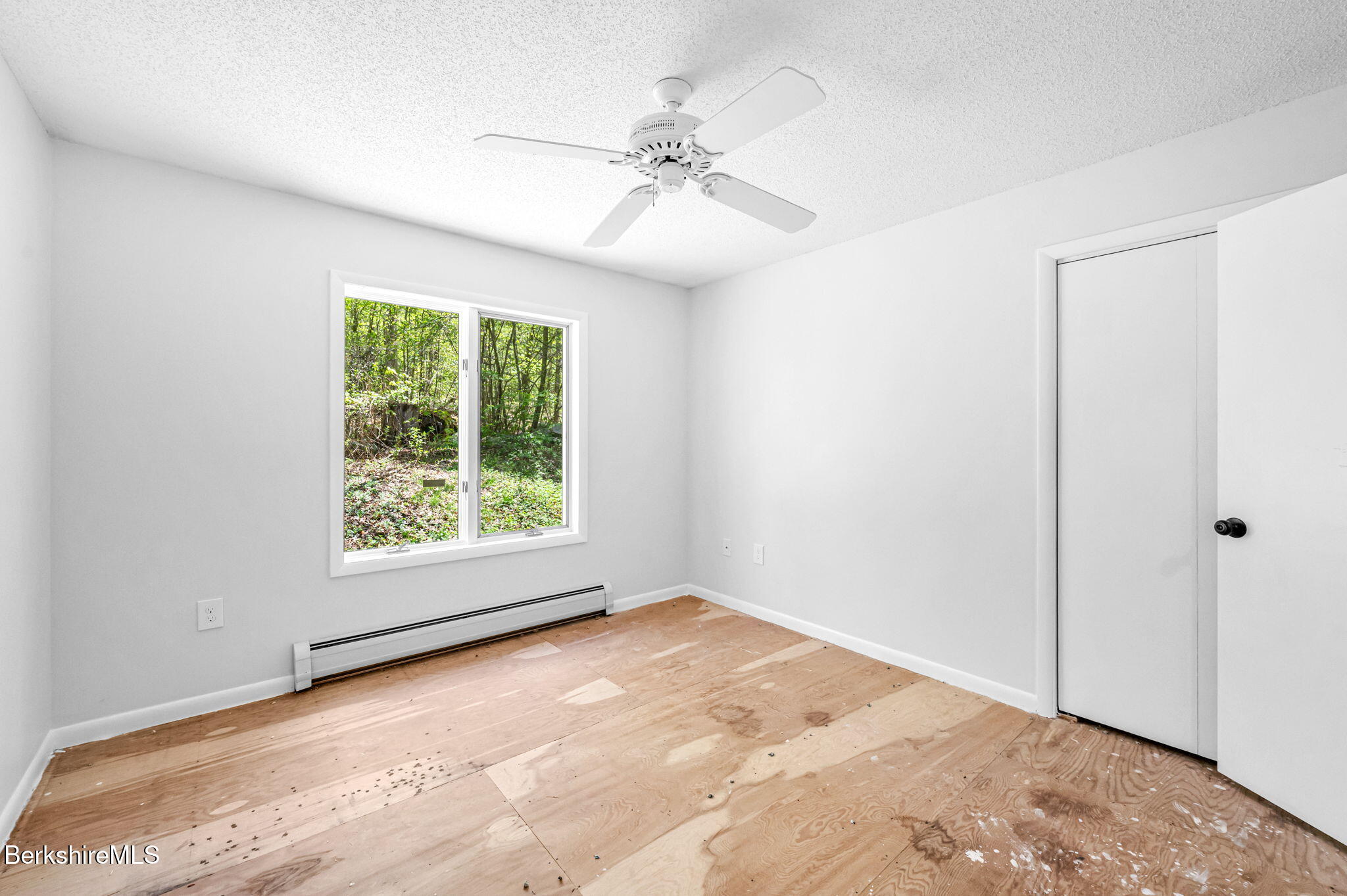 1874 Home Road Sheffield, MA 01230 - Photo 25 of 42 an empty room with a window and a ceiling fan