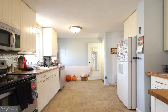 a kitchen with a sink stove and refrigerator