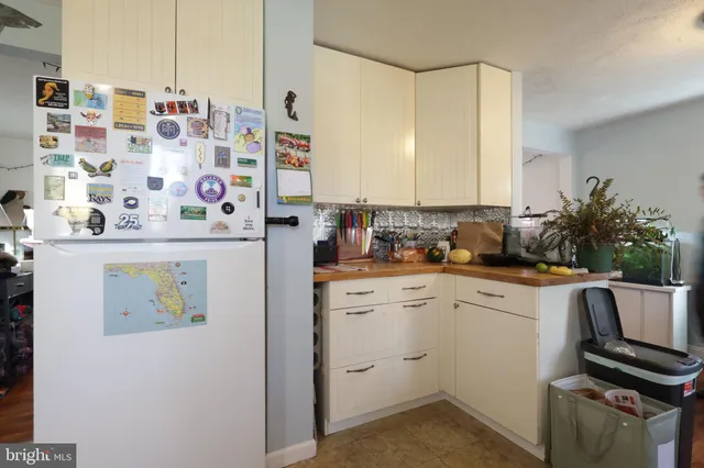 a kitchen with a refrigerator and sink