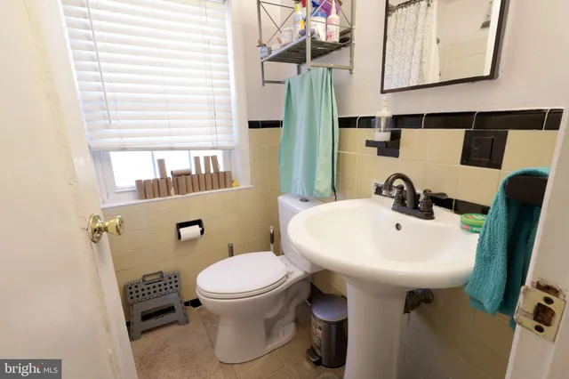 a bathroom with a sink a toilet and mirror