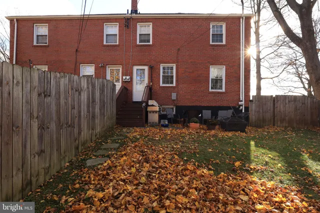 a brick building view with a backyard space