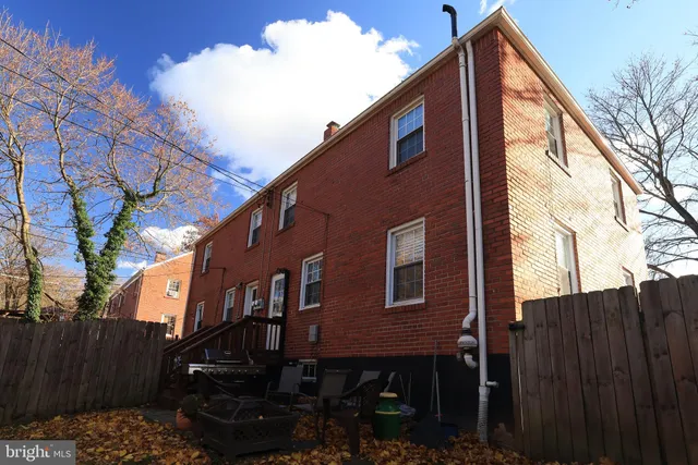 a red brick house with trees in front of it