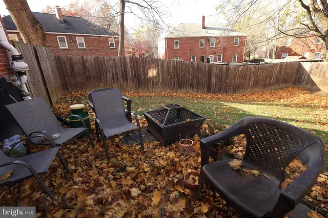 a view of a chairs and table in backyard