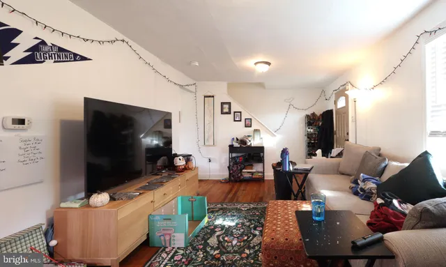 a living room with furniture and a flat screen tv