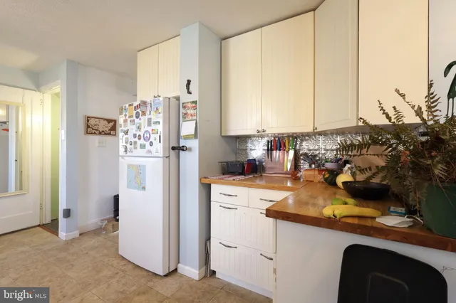 a kitchen with a refrigerator and a stove