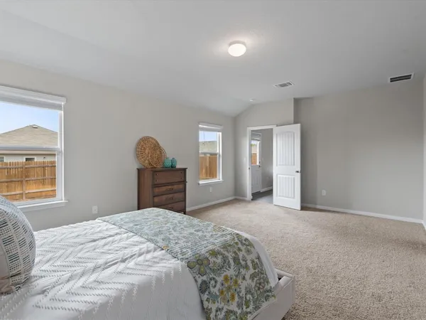 a bedroom with a bed and window