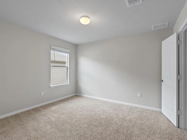 a view of an empty room and closet area