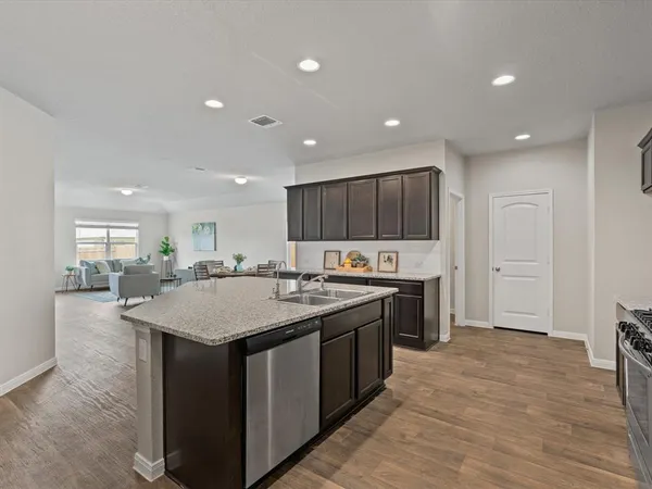 a kitchen with kitchen island a sink stainless steel appliances and cabinets