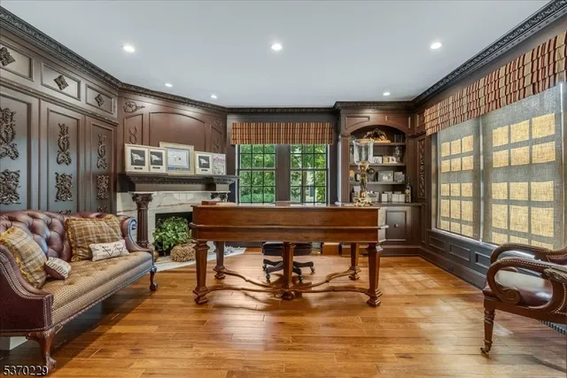 a living room with furniture a fireplace and large windows