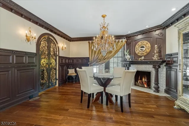 a view of a dining room with furniture and chandelier