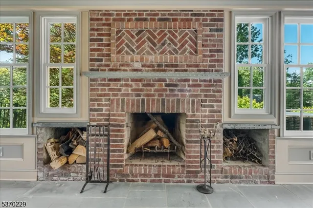 a living room with a fireplace and a window