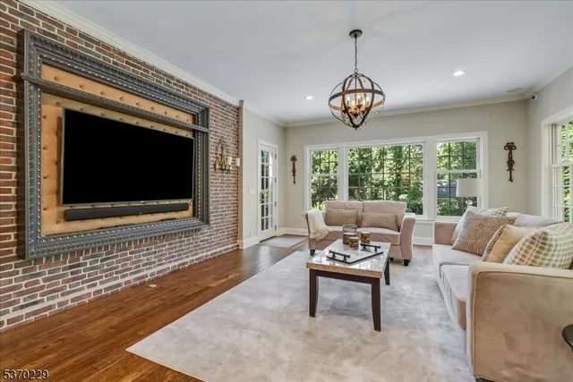 a living room with furniture a window and a flat screen tv