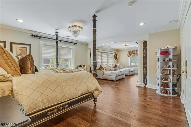 a bedroom with furniture and wooden floor