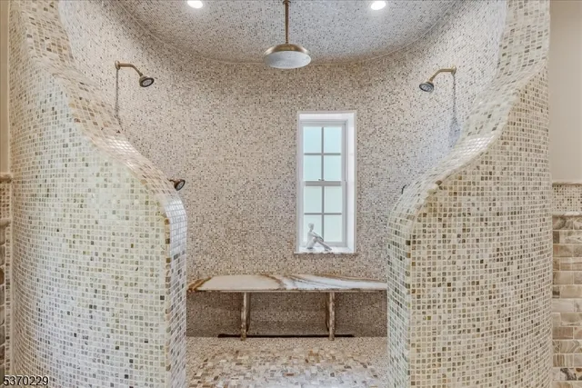 a bathroom with a bathtub and shower