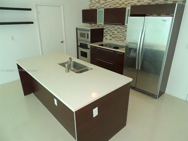 a kitchen with stainless steel appliances a refrigerator and a stove