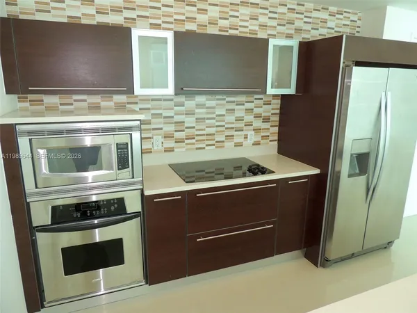 a stove top oven sitting inside of a kitchen