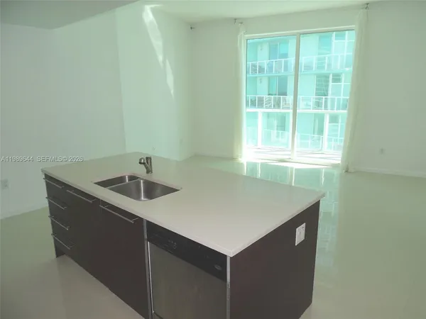 a kitchen that has a sink and a table in it