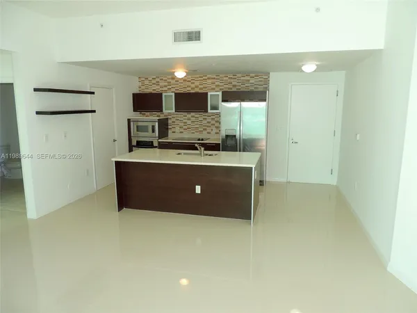 a kitchen with stainless steel appliances a refrigerator and a stove