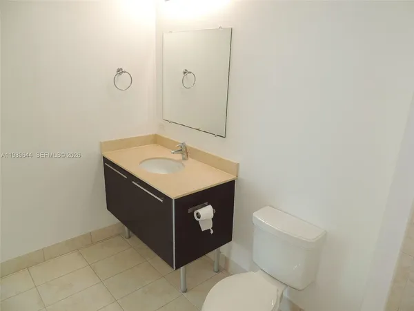 a bathroom with a sink vanity and toilet