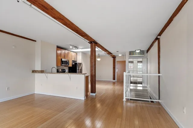 a view of a kitchen with a refrigerator a stove top oven and a refrigerator