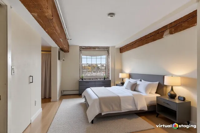 a bedroom with a bed and a night stand