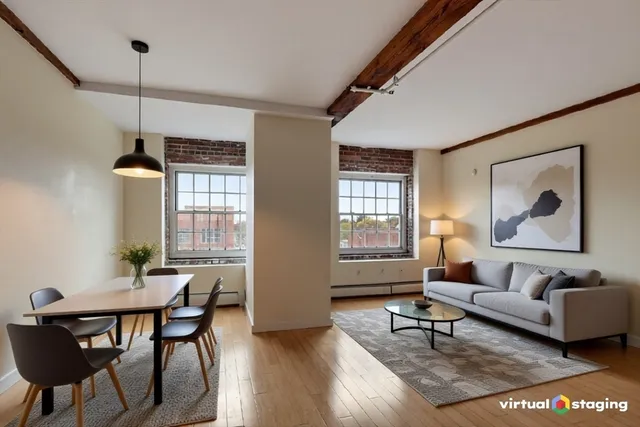 a living room with furniture a window and a dining table with wooden floor