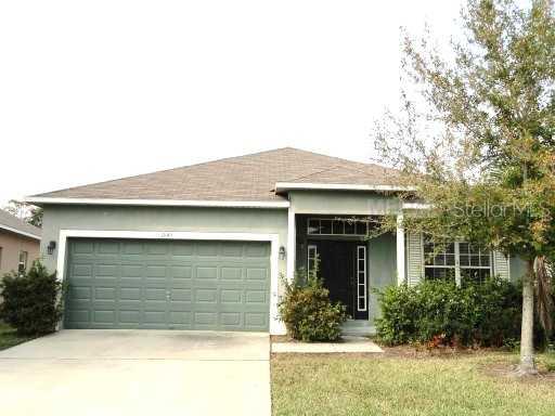 1845 Great Falls Way Orlando, FL 32824 - Photo 1 of 1 a front view of a house with garden