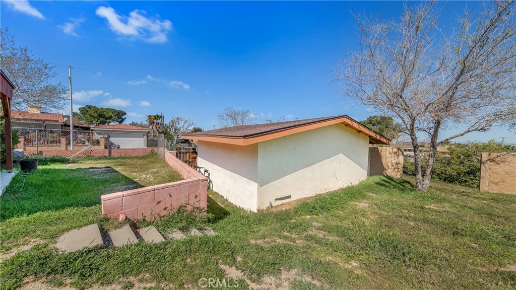 1549 Elizabeth Lake Road Palmdale, CA 93551 - Photo 19 of 27 a view of a house with a yard