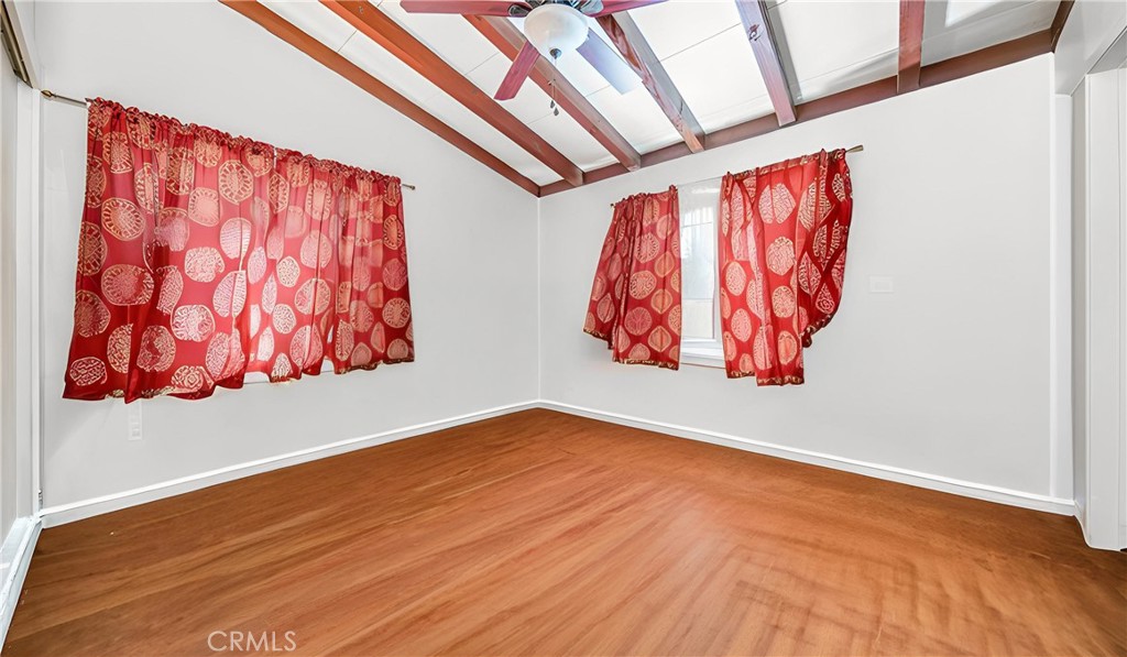 1549 Elizabeth Lake Road Palmdale, CA 93551 - Photo 24 of 27 a view of an empty room with wooden floor and a window