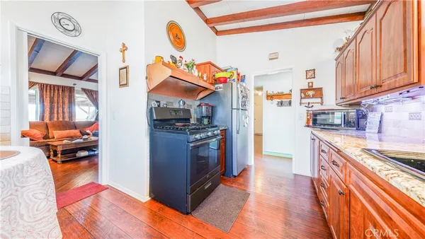 a kitchen with stainless steel appliances granite countertop a refrigerator and a stove top oven