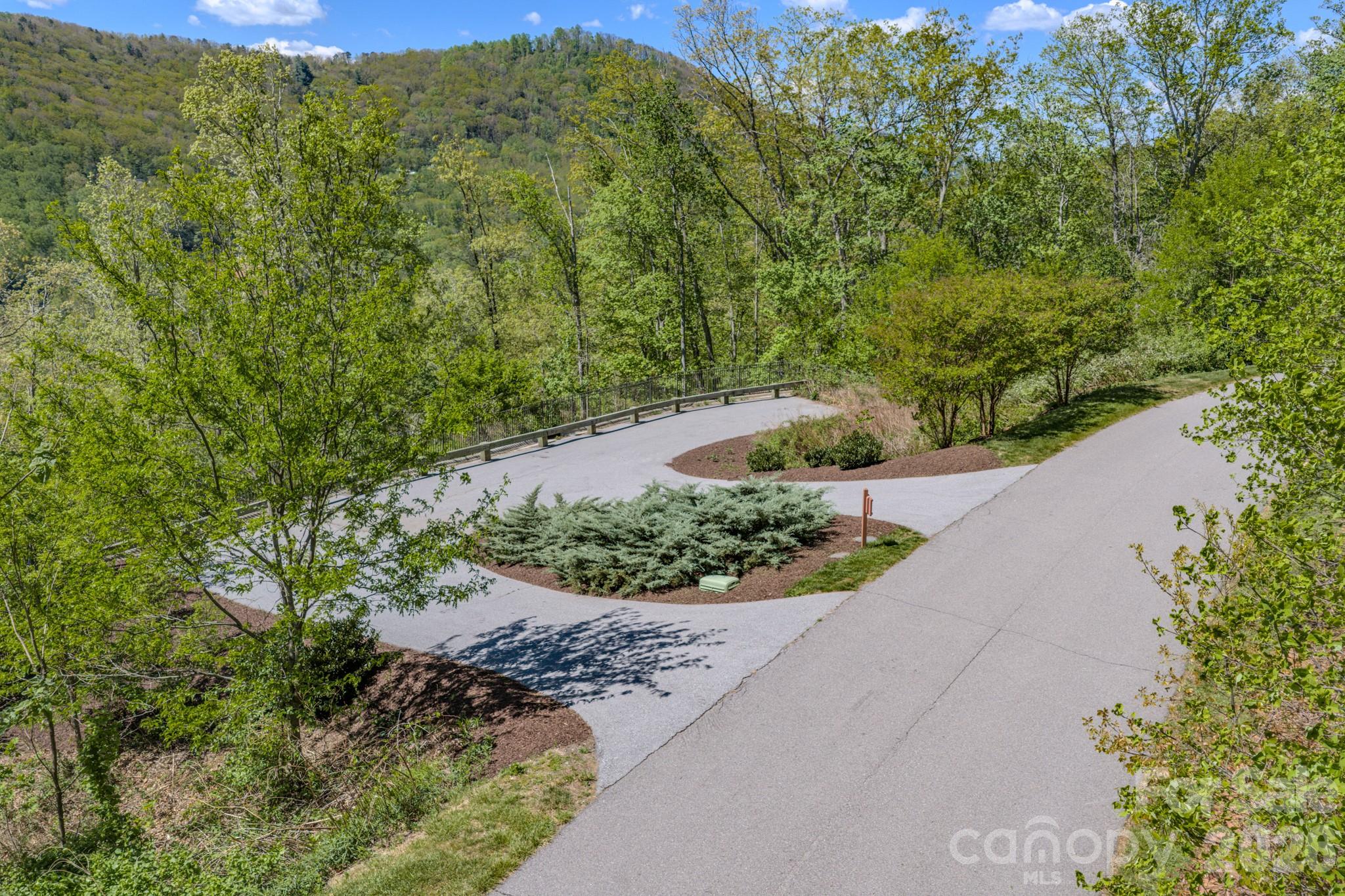 67 Clear Water Trail Road, Unit 511 Fairview, NC 28730 - Photo 8 of 12 a view of a garden with a pathway