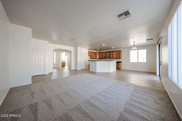 a big room with wooden floor and windows