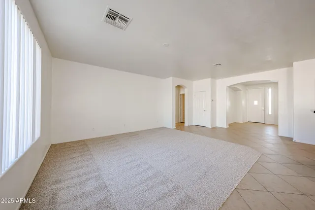 an empty room with a empty space and windows