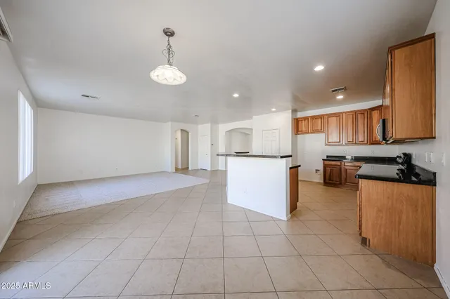 a open kitchen with cabinets and stainless steel appliances