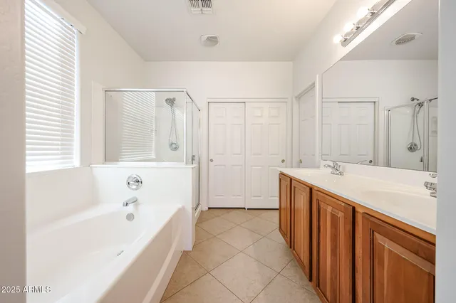 a bathroom with a tub sink and mirror