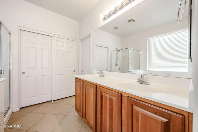 a bathroom with a double vanity sink and a mirror