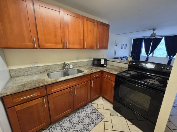 a kitchen with sink cabinets and appliances