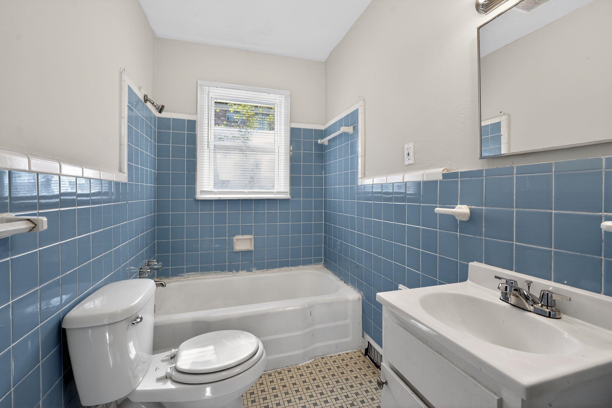 4094 Auburn Road Memphis, TN 38116 - Photo 19 of 30 Bathroom with vanity, tile walls, shower / bathtub combination, and wainscoting