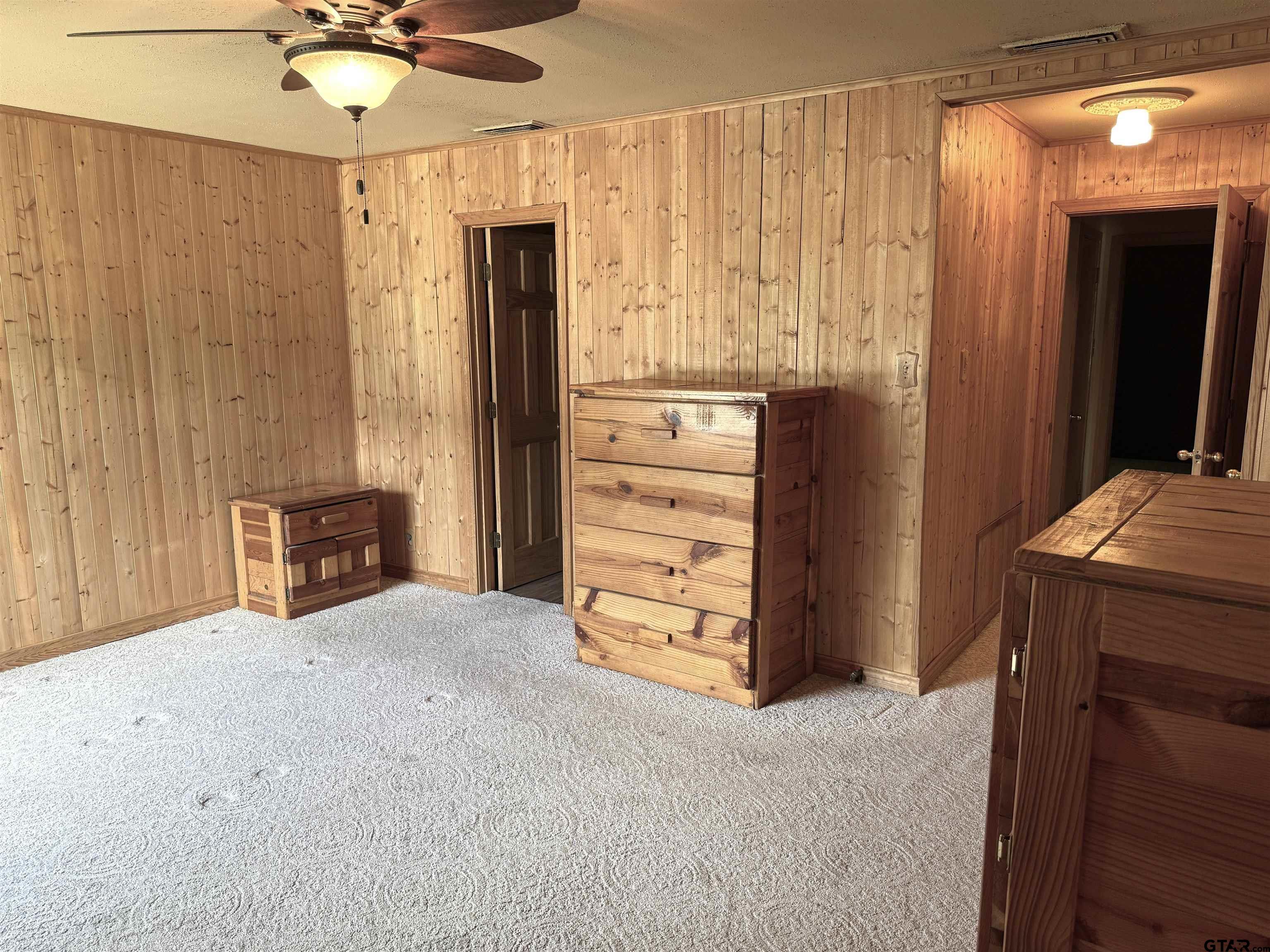 2015 East 5th Street Tyler, TX 75701 - Photo 12 of 32 a view of a bedroom with closet and ceiling fan