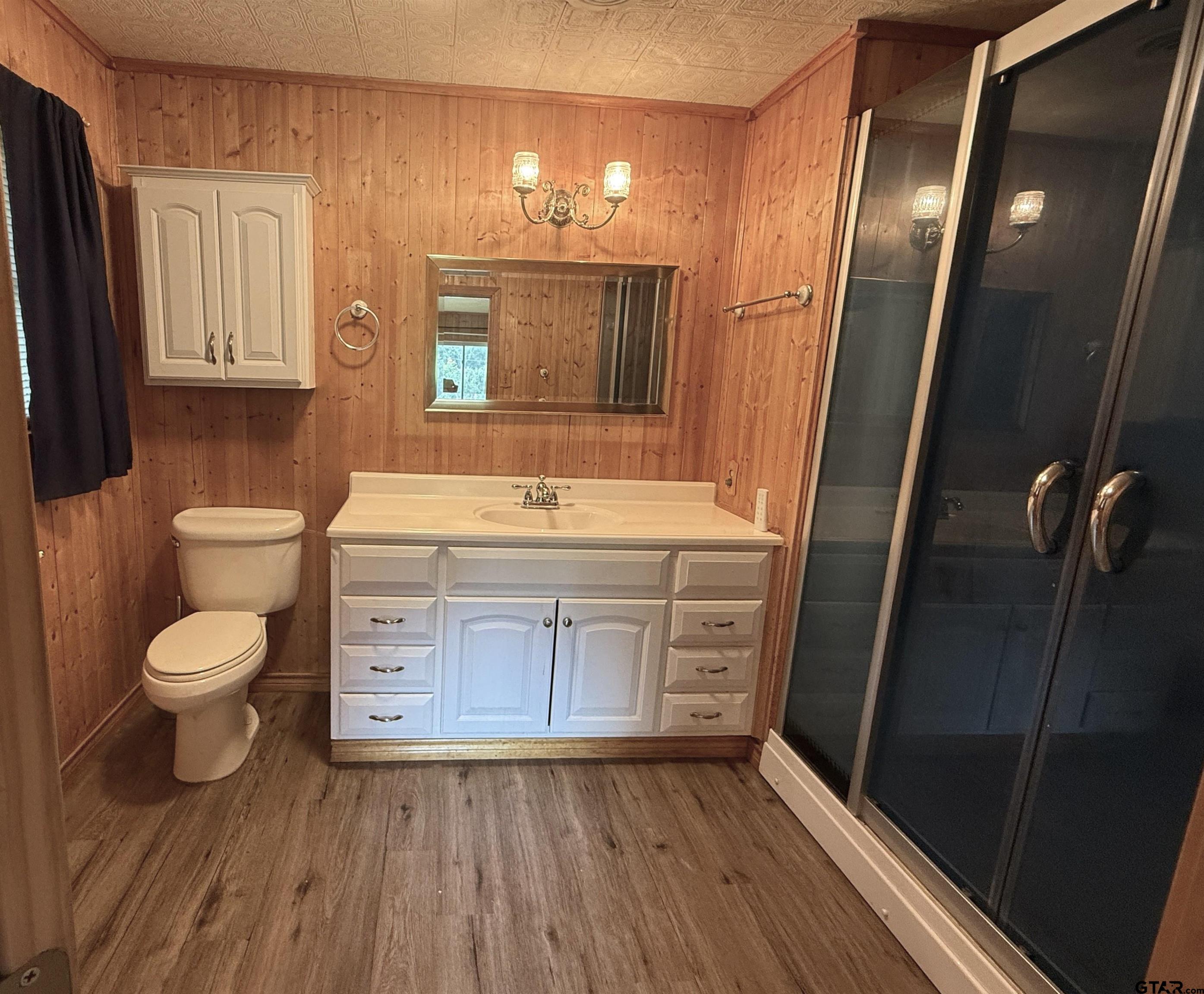 2015 East 5th Street Tyler, TX 75701 - Photo 15 of 32 a bathroom with a sink a toilet and mirror