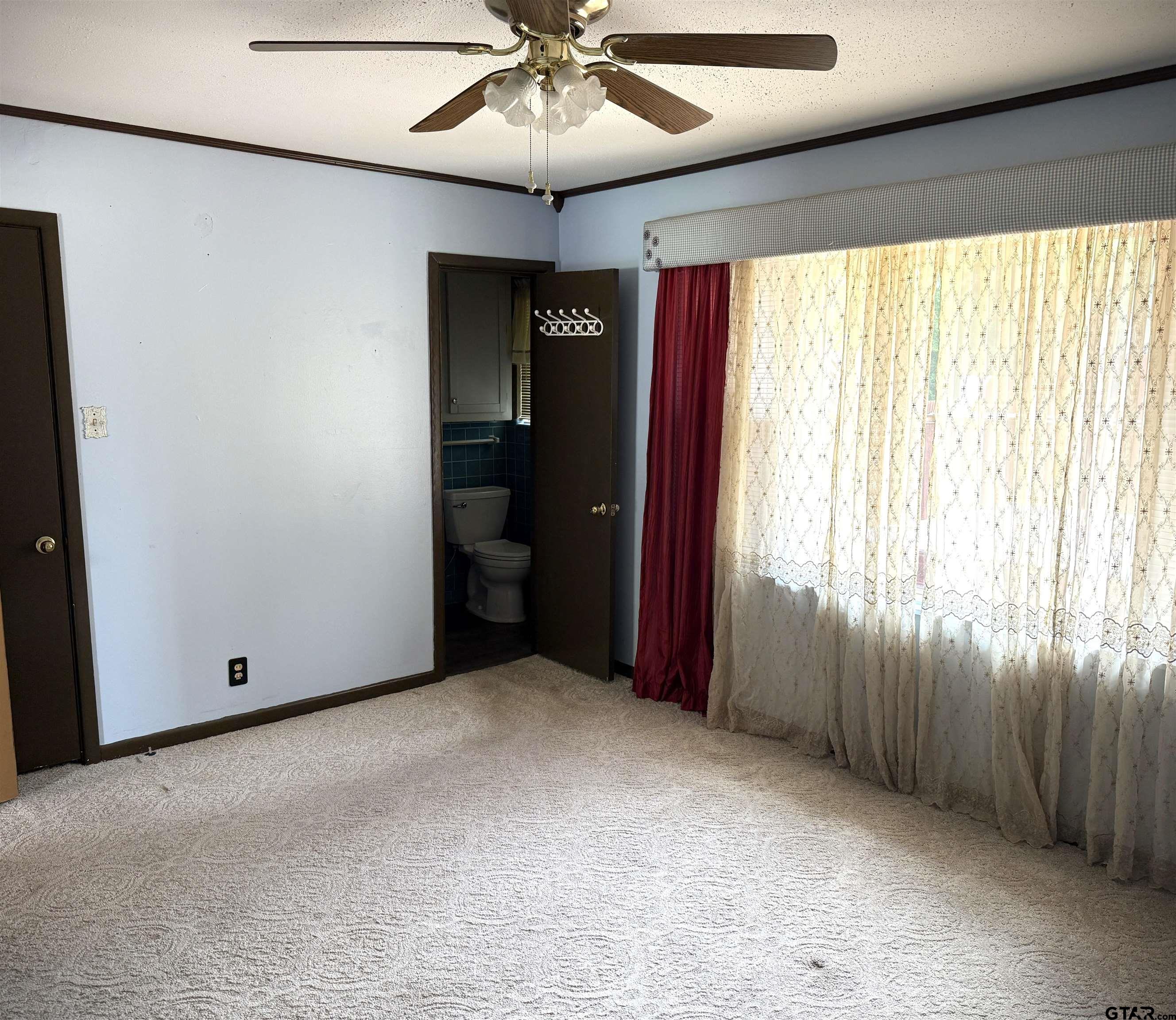 2015 East 5th Street Tyler, TX 75701 - Photo 16 of 32 an empty room with windows and fan